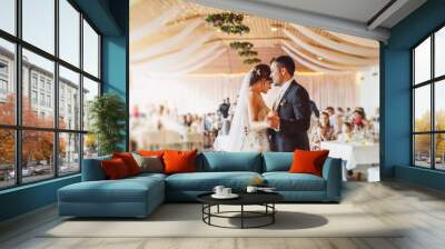 Happy just married young couple at the first wedding dance Wall mural