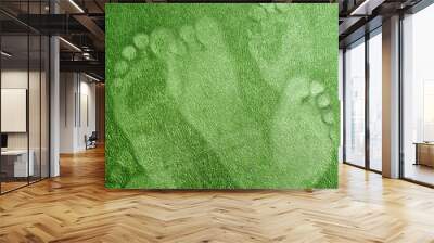 Imprints of the human foot on a soft surface. Wall mural