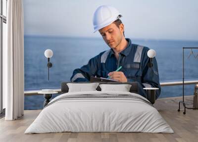 Engineer with clipboard working in port Wall mural