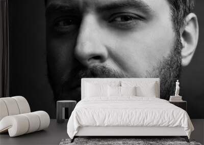 Low key black and white  portrait of a serious thinking man with a thick beard Wall mural