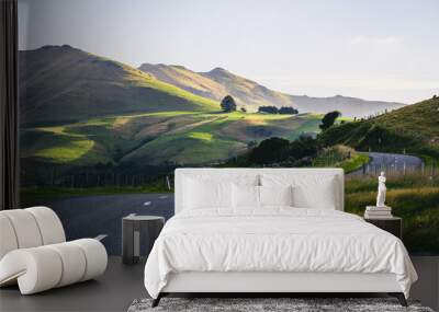 Long rural road leading to the mountains in Akaroa, New Zealand Wall mural