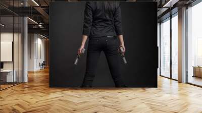 Young woman with pistols Wall mural