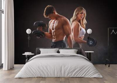  smiling woman an man with dumbbell - successful fitness studio concept Wall mural