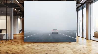 a car on the freeway in the heavy fog Wall mural