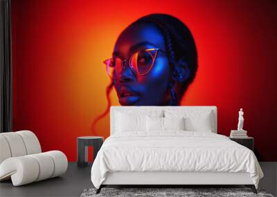 Portrait of fashion young girl in cool glasses in red and blue neon light in the studio Wall mural