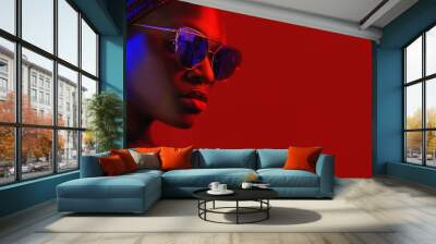 Portrait of fashion young girl in cool RED sunglasses in red and blue neon light in the studio Wall mural