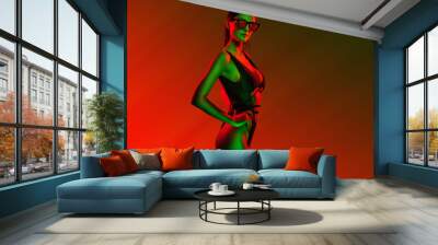 stylish girl portrait near pink green neon light sign. Portrait in cool neon light. Wall mural