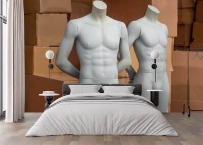 Mannequins of men on the background of cardboard boxes with clothes. Wall mural