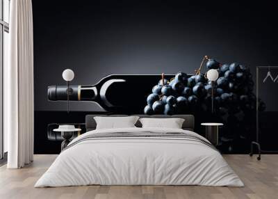 Bottle of red wine and a bunch of grapes on a black reflective background. Wall mural