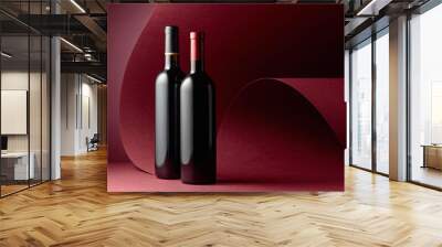 Bottles of red wine on a red background. Wall mural