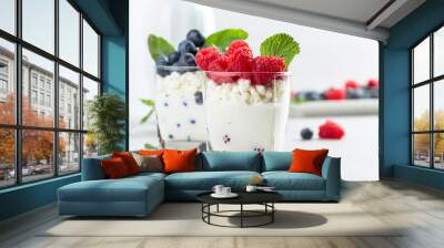 Cottage cheese with cream, raspberry and blueberry garnished with fresh mint. Wall mural