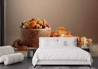 Dried fruits and nuts on a beige ceramic table. Wall mural