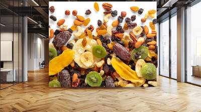 Dried tropical fruits, nuts, and raisins isolated on white. Wall mural