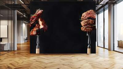 Grilled pork belly and beef steak with rosemary on a black background. Wall mural