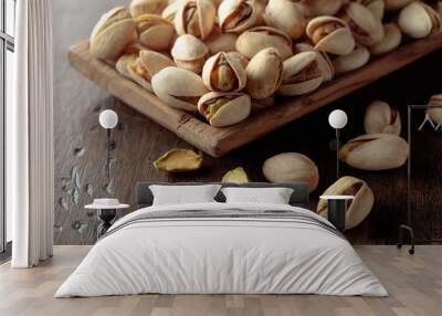 Salted pistachios on an old wooden table. Wall mural