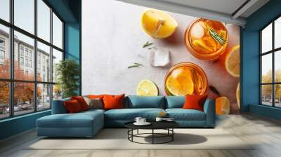 Traditional iced tea with lemon, lime and ice garnished with rosemary twigs. Wall mural