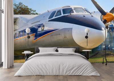 Old propeller driven passenger plane parked Wall mural