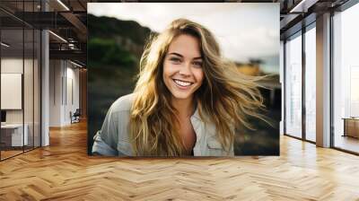 Portrait of a beautiful young woman with long blond hair on the beach Wall mural