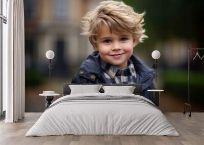 Portrait of a cute little boy with blond hair and blue eyes Wall mural