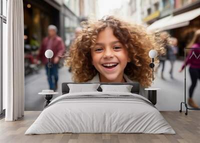 Portrait of a cute little girl with curly hair in the city Wall mural