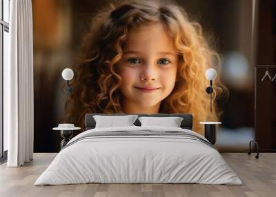 Portrait of a cute little girl with curly hair looking at camera Wall mural