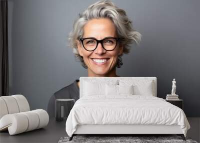 Portrait of a happy mature woman with grey hair and eyeglasses Wall mural