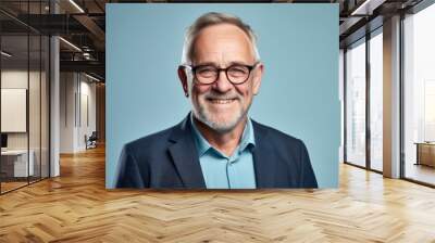 Portrait of happy senior businessman with eyeglasses over blue background. Wall mural