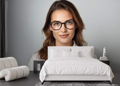 Portrait of young business woman in eyeglasses on grey background Wall mural