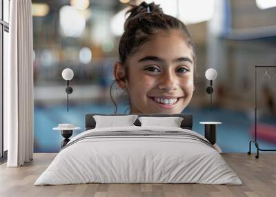 Smiling young gymnast in gym, focused and poised Wall mural