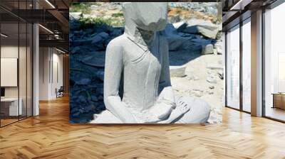 Creating a stone sculpture of a seated Buddha Wall mural