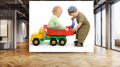 Two little boys play with toy truck Wall mural