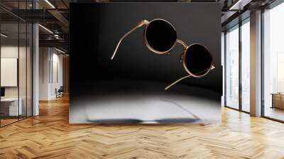 sunglasses levitate on a dark background, play of light Wall mural