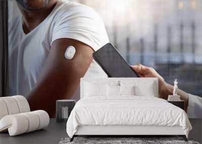 A close-up of a person's arm with a wearable device of real-time control of health through continuous glucose monitoring CGM system being scanned by a smartphone, showcasing health technology. Wall mural