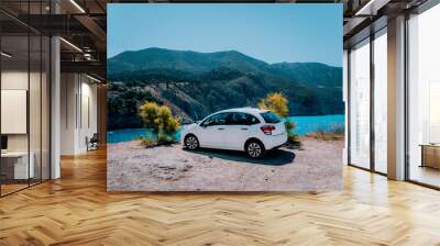 Vacation travel with car concept. Rental hired car in front of amazing bay with turquoise water. Discover Mediterranean Islands. Summer time holiday trip Wall mural