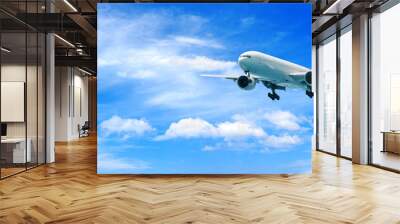 Passenger airplane flying above clouds. View from the window plane to amazing sky with beautiful clouds. Wall mural