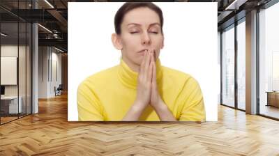 young woman praying isolated white Wall mural