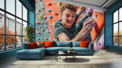 young athletic man wearing sportswear climbing wall indoors, smiling portrait Wall mural