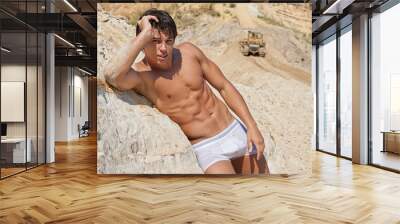 Sexy wet muscle young boy lean against sands Wall mural