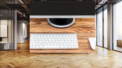 Computer mouse, keyboard and monitor on the desk near wall. Wall mural