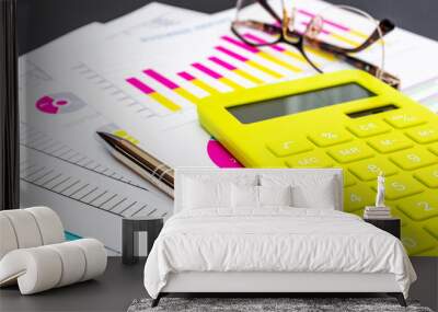 Financial documents with calculator, pen and eyeglasses on black background. Wall mural