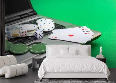 laptop with poker chips, playing cards, money and dice on green background. online casino. Wall mural