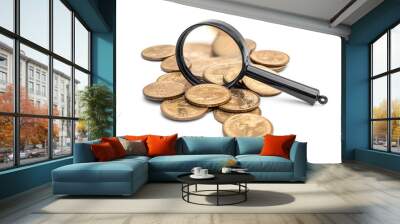 Magnifying glass on the pile of coins on white background. Wall mural