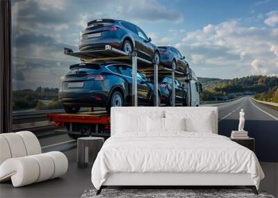 Tow truck car carrier semi trailer on highway carrying batch of new wrapped electric SUVs on motorway Wall mural