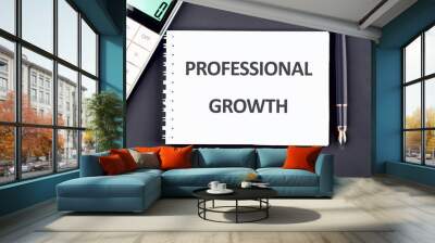 Business concept. The phrase, text, and words of PROFESSIONAL GROWTH are written in a notebook on a dark blue background Wall mural