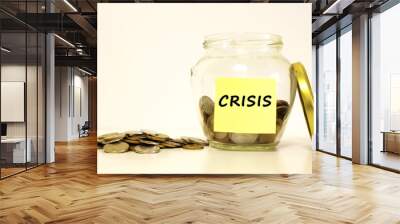 Glass jar with coins for savings. The inscription on the note paper CRISIS. Financial concept. Wall mural