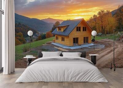 A wooden house stands alone as the sun sets behind the mountains Wall mural