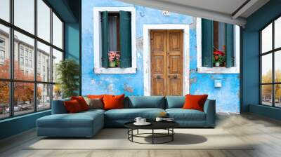 Colourful house on the island of Burano. The facade of a blue house with a laundry rack outside in Burano, Venice, Italy. Burano is near Venice, and is famous for its canals and charming. - Immagine Wall mural