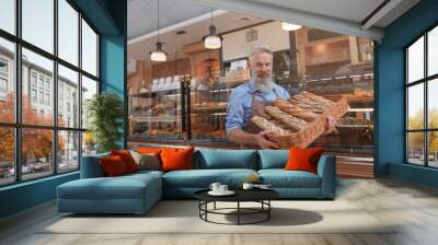 Happy proud senior baker working at his bakery, selling delicious fresh bread, copy space Wall mural