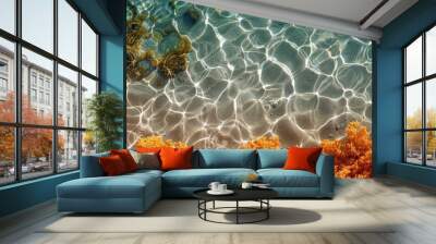 Ocean floor close-up: blue water, sand, and orange coral Wall mural