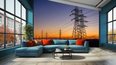 High voltage power line in a field at sunset Wall mural